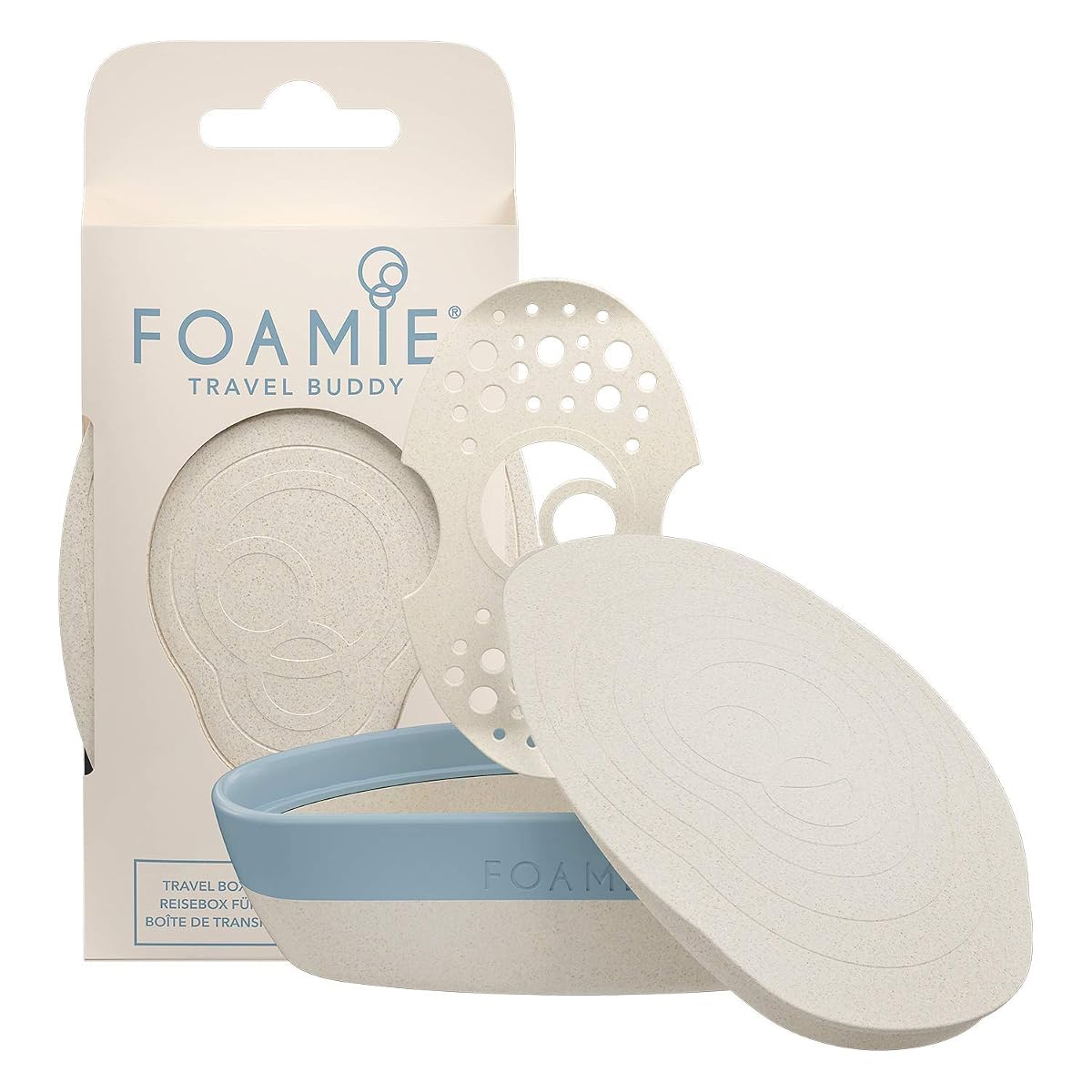 Boîte à savon de voyage beige et bleue avec fermeture en silicone, posée près d’un savon solide