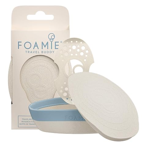 Boîte à savon de voyage beige et bleue avec fermeture en silicone, posée près d’un savon solide